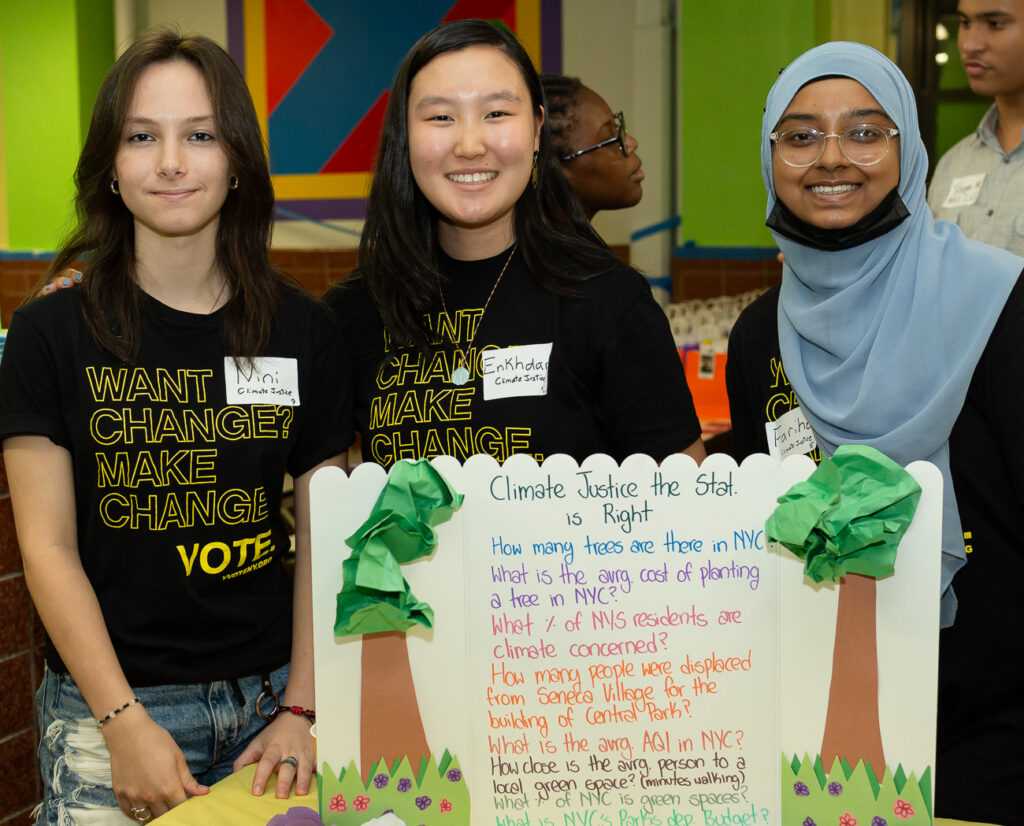 Image of girl registering students to vote at a table